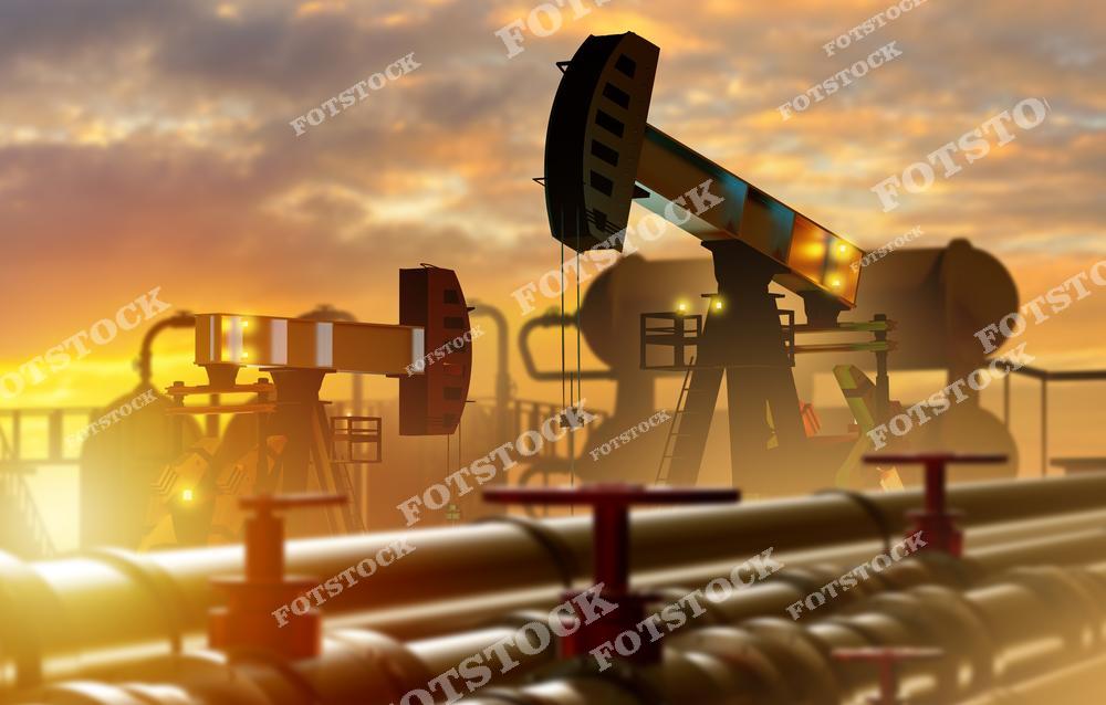 На изображении силуэты нефтяных качалок, работающих на фоне яркого заката, также видны трубопроводы с запорными вентилями. Снимок символизирует процессы добычи нефти и важность энергетического сектора в промышленности.